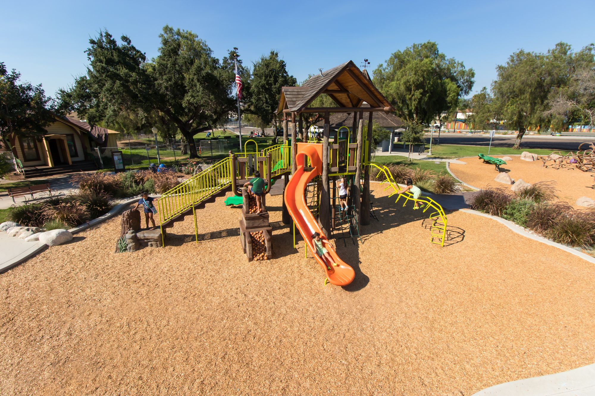Logged themed playground with orange slide
