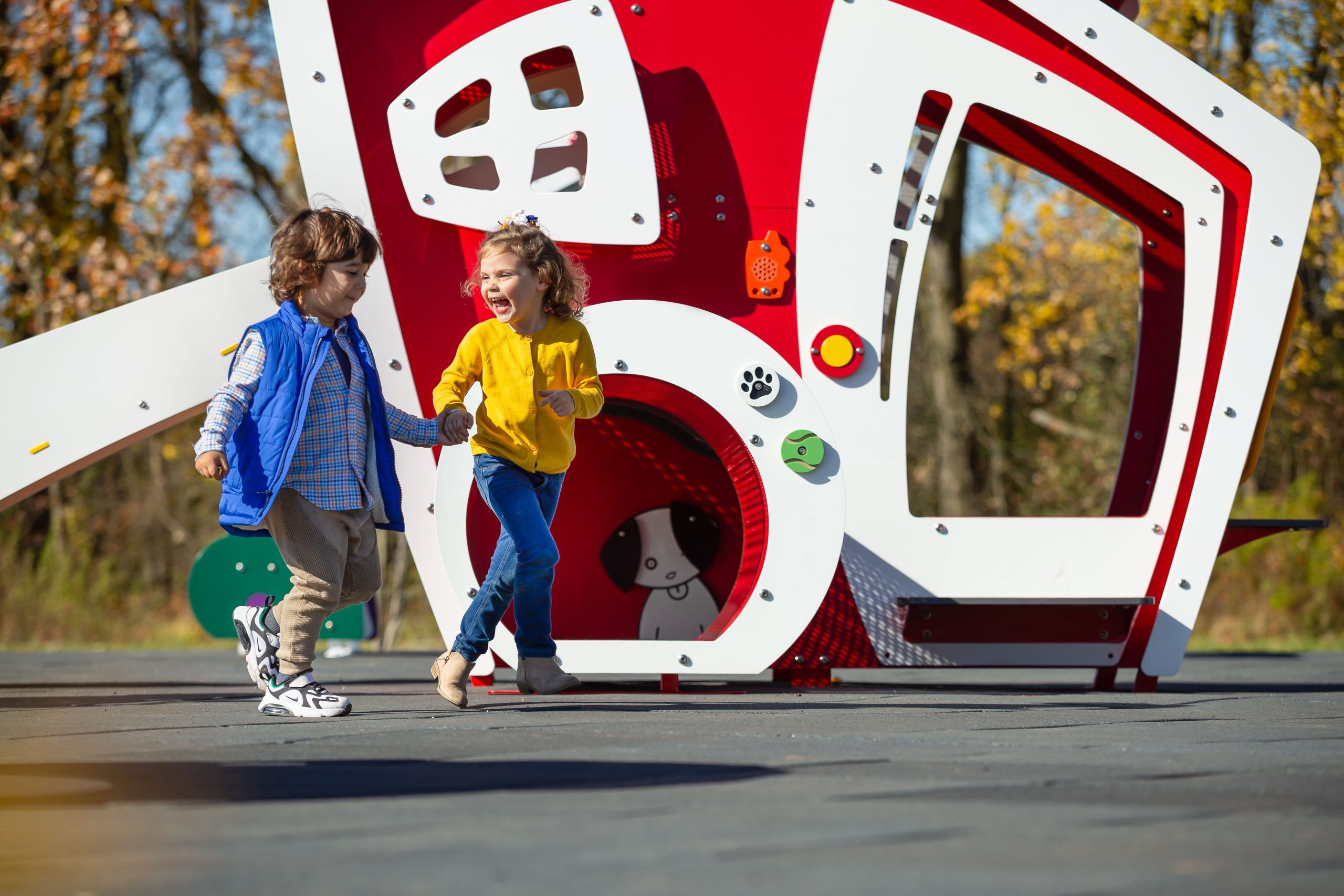 Toddlers holding hands on park playground