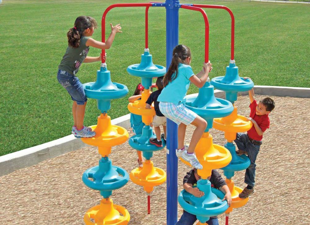 children climbing up sensory climber with many vertical disks