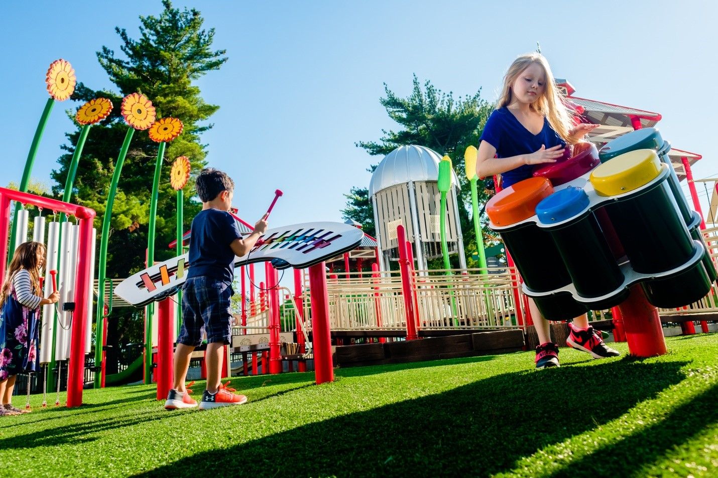 Children playing on concerto outdoor playground instruments