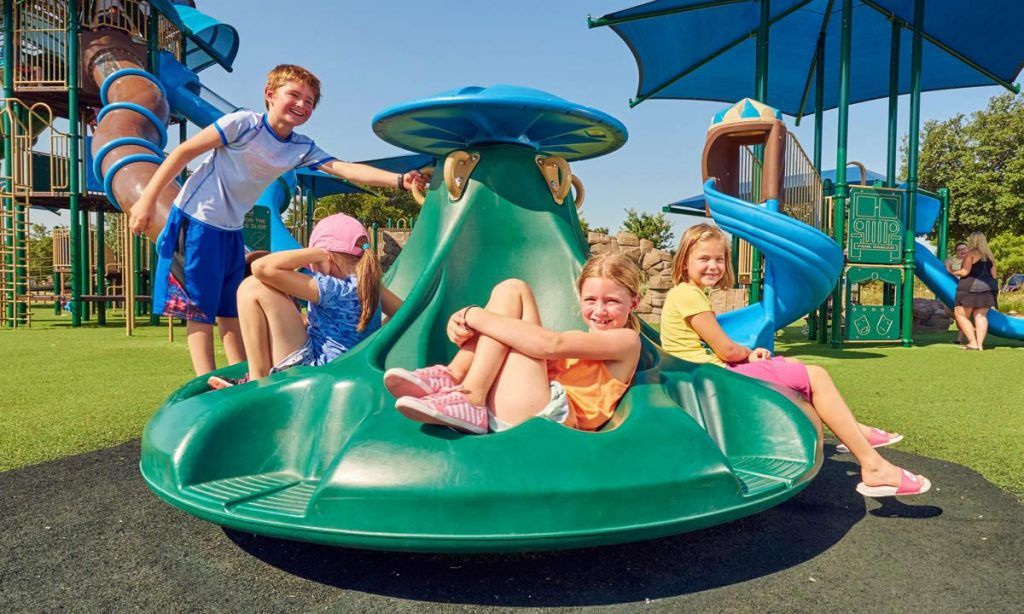 Group of children on green ten spin