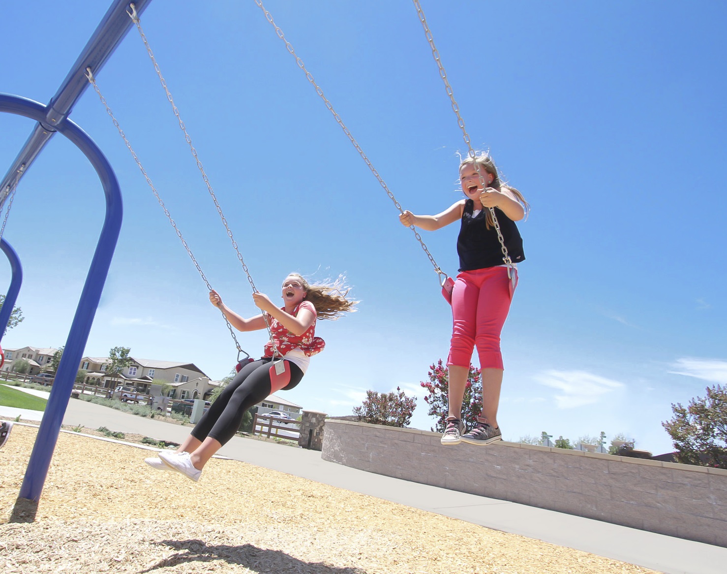 two girls swinging