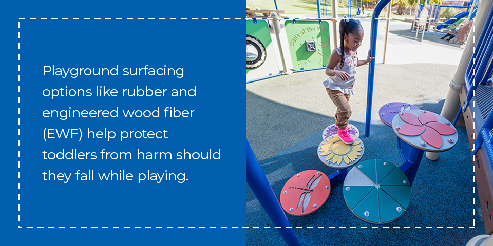 Playground surfacing like rubber or engineered wood fiber help protect toddlers from harm should they fall while playing.